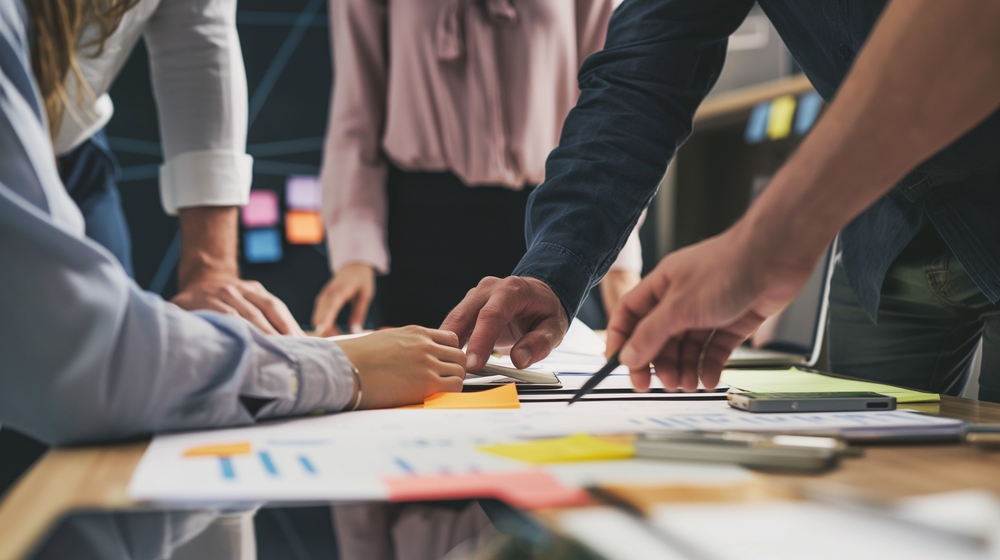 People analyzing business assessment on table