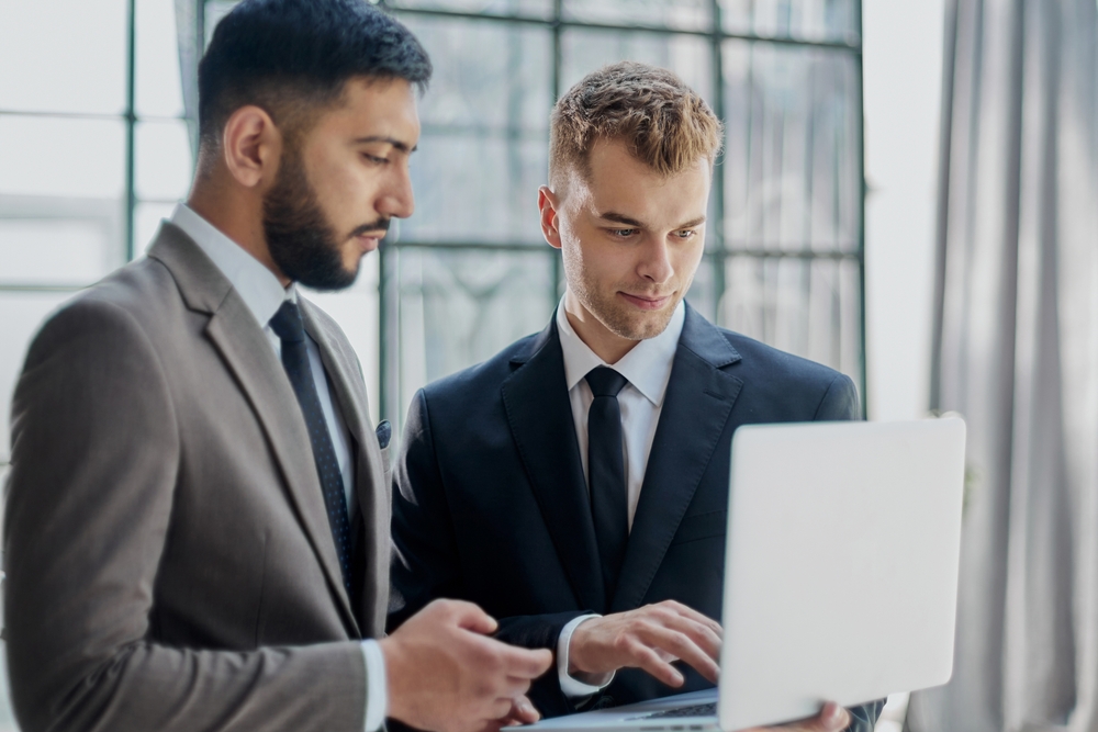 two businessmen looking at laptop